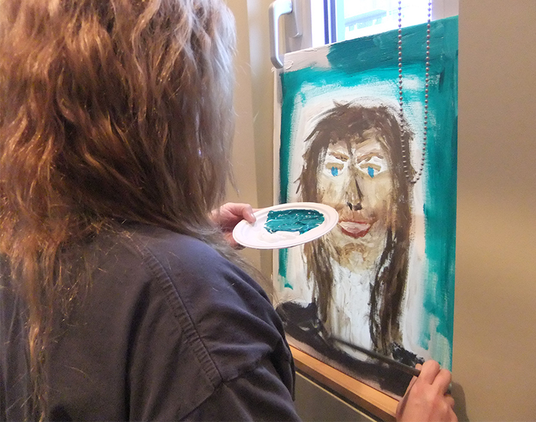 Person painting a self-portrait