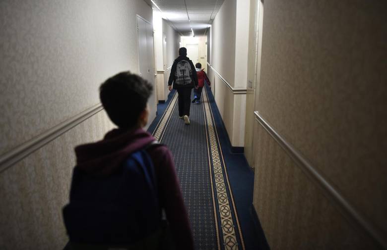 Ahmad Al Rasoul’s sons head down the hallway to their apartment after school was over at nearby Thorncliffe Park School.