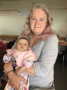 A woman holding a baby.