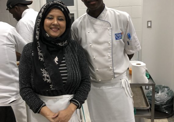 Woman and man chefs in a kitchen