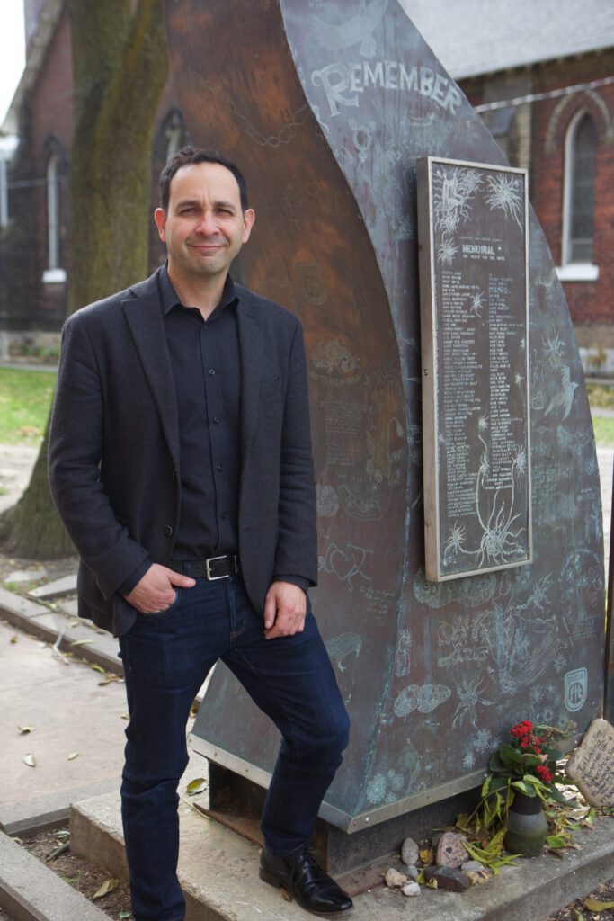 New chief executive officer standing in front of memorial sculpture