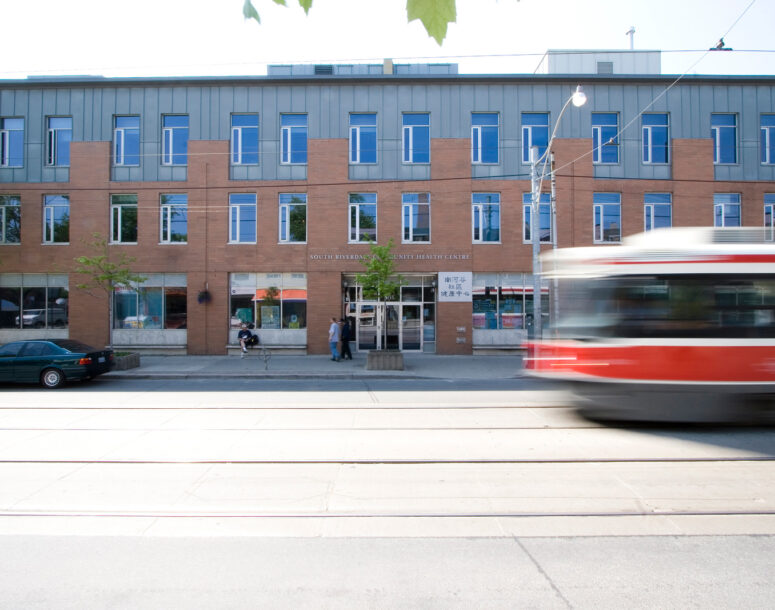 Street level view of 995 Queen with a TTC streetcar passing by