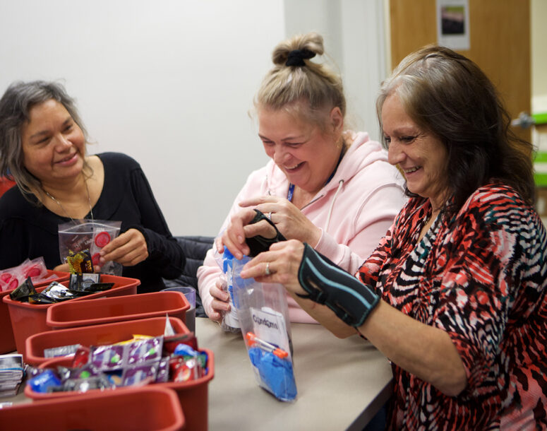 Women gathered making care packages