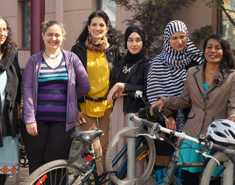 A group of newcomers standing in front of a bike rack