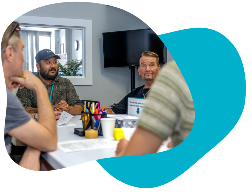 Four people sit around a table, having a conversation