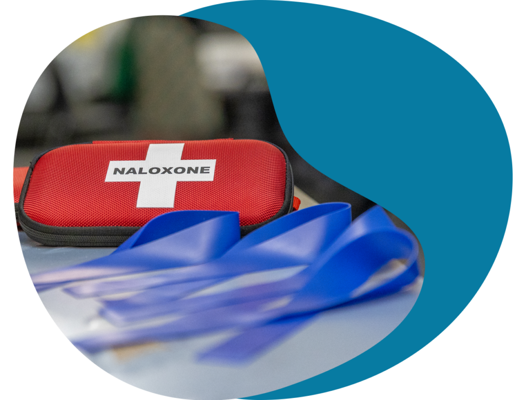 A counter with a naloxone kit and safer supply materials