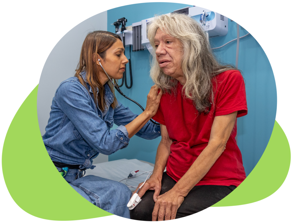 A health professional uses a stethescope on the back of a client